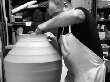 Darren McGinn StudioMade, at work - throwing a clay form on the potter's wheel.