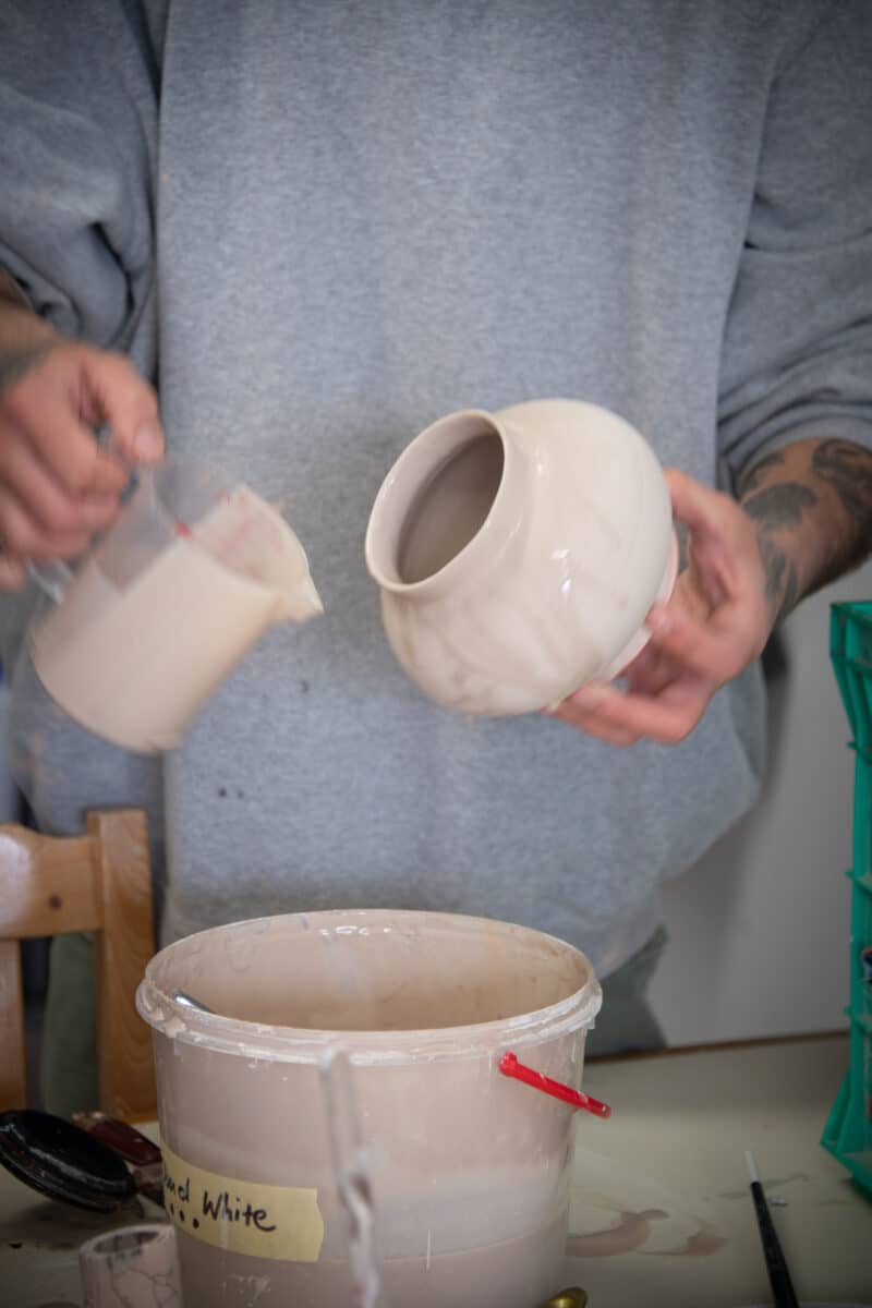Person glazing ceramic ware