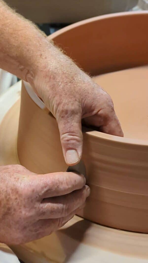 Throwing a large clay form on the potter's wheel