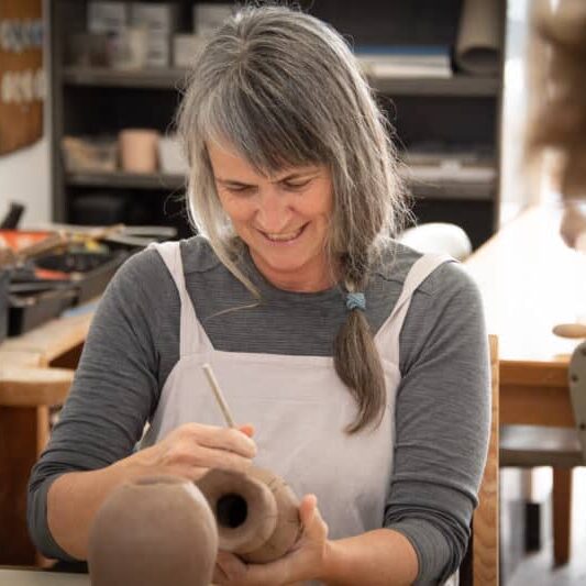 Student glazing ceramics at pottery studio in Geelong - StudioMade